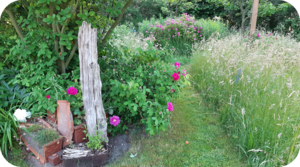 Schöner Garten mit Holzplankenskulptur